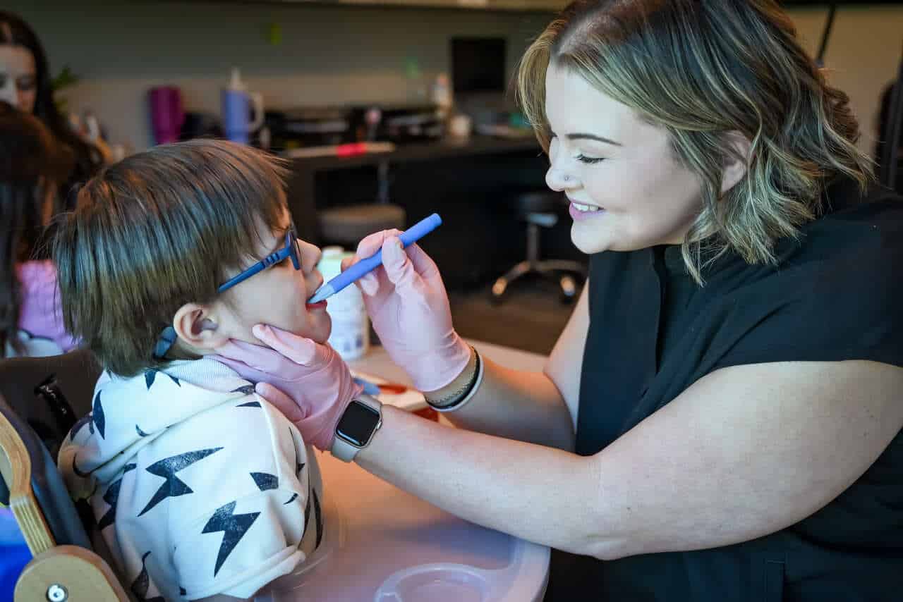 Mackenzie feeding a boy child patient